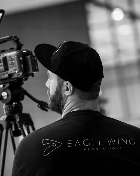 Eagle Wing Productions camera operator behind a cinema camera on a tripod, video production for Park City businesses
